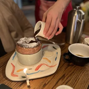 Pouring chocolate on the soufflé