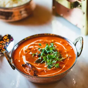 a bowl of soup and a plate of rice