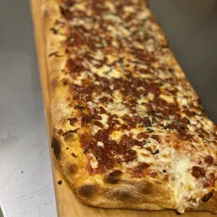 a pizza on a cutting board