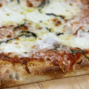 a close up of a pizza on a cutting board