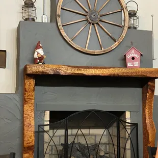 a fire place with a wagon wheel on top