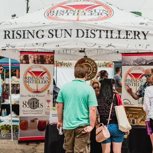 a group of people standing under a tent