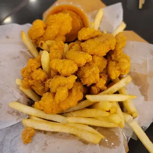 Popcorn chicken and fries with a sesame dipping sauce