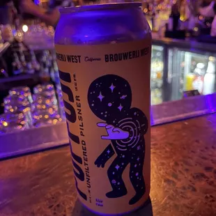 a can of beer on a bar counter