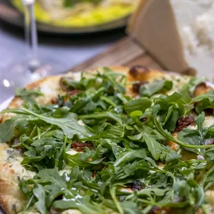 a pizza and a glass of wine