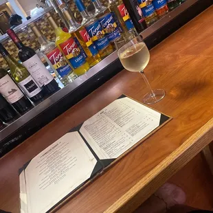 a glass of wine and a menu