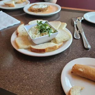 Artichoke dip, a mozzarella stick, and fried mushroom in the back - appetizers