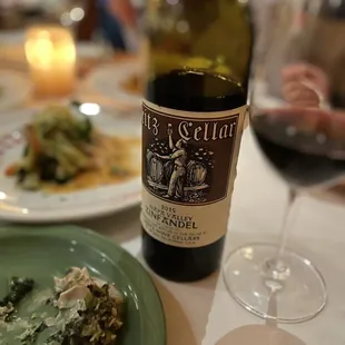 a plate of food and a bottle of wine