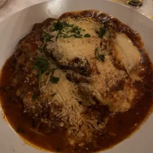 MELANZANE PARMEGIANA Eggplant breaded topped with tomato sauce, mozzarella cheese with pasta