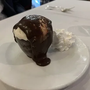 BACIO DI NAPOLI / KISS OF NAPLES   A chocolate cup filled with vanilla ice cream, zabaglione sauce then topped with chocolate sauce.