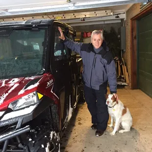 Gene and Remmi by our Polaris 1000 on a snowy winter day in the Utah mountains