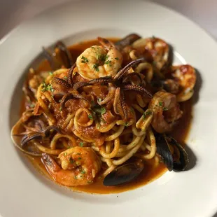 a plate of pasta with seafood