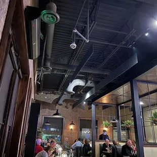 people sitting at tables in a restaurant