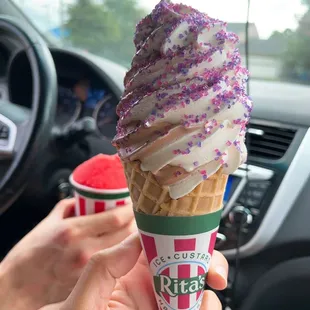 a person holding a cone of ice cream