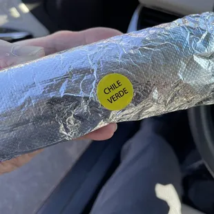 a person holding a burrito