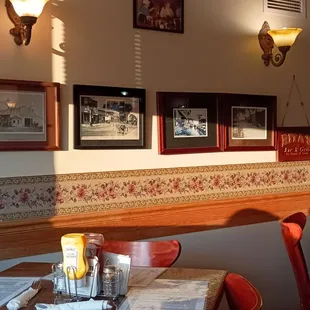 a dining area with a table and chairs