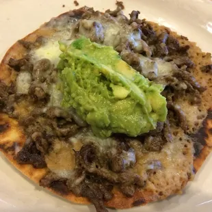 Taco Norteno: toasted flour tortilla topped with cheese, carne asada, and guacamole