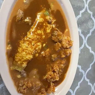 Cheese enchilada Christmas style with a side of rice.