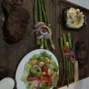 Filet with a salad. Other filet with mashed potatoes.