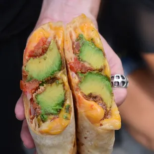 a person holding a burrito