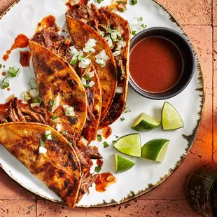 a plate of quesadillas and a glass of beer