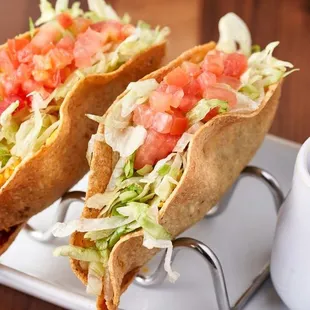 two tacos with lettuce and tomatoes