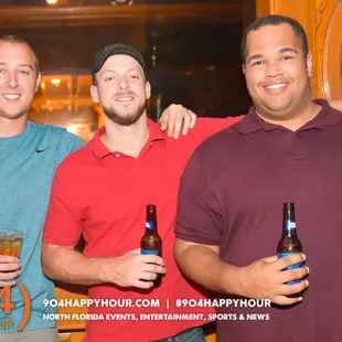 a group of men holding beers