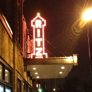 a neon sign on the side of a building