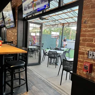 Guests throwing corn hole on the patio