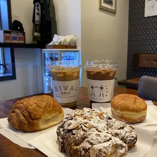 Latte (w oat milk and iced),  Mocha (w oat milk and iced), (left to right): chocolate croissant, almond croissant, beignet