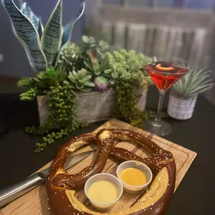 a pretzel and two dipping sauces