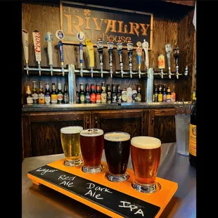 a row of beer glasses on a bar