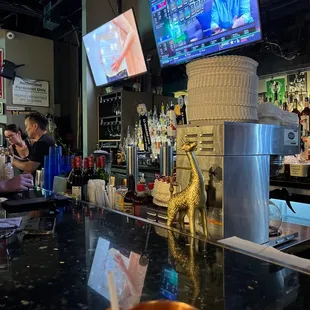 a bar with a bowl of fruit on the counter