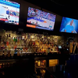 a sports bar with multiple television screens