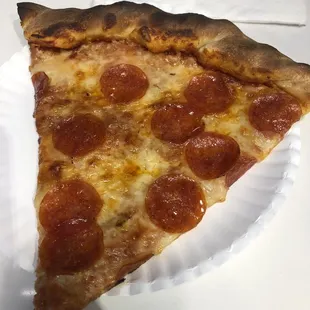 Slice of pepperoni pizza from outside window.