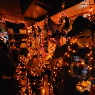 a group of people standing in front of a display of christmas lights