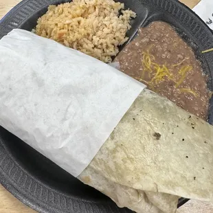 a burrito with rice and beans