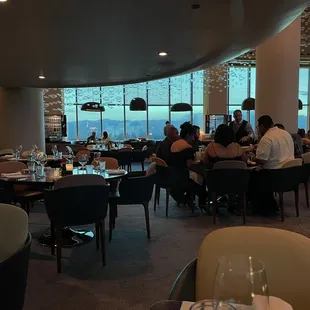 people sitting at tables in a restaurant