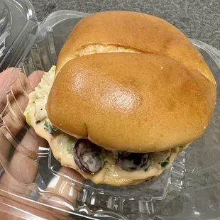 a hand holding a sandwich