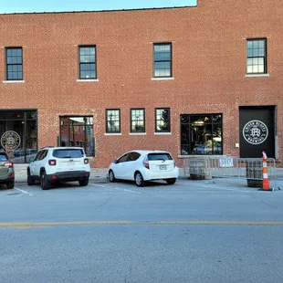  two cars parked in front of the building