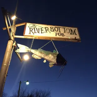 Looks like a sign with a catfish hanging off of it.