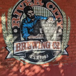 a man holding a barrel of beer