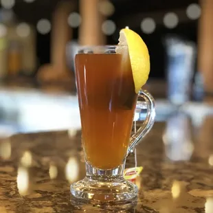 a glass of tea with a lemon wedge