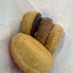 Strawberry frosted (top) chocolate frosted, blueberry cake, glazed