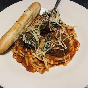 a plate of pasta and a hot dog