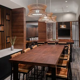 a dining room with a long table and chairs