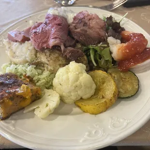 a plate of meat, vegetables, and rice