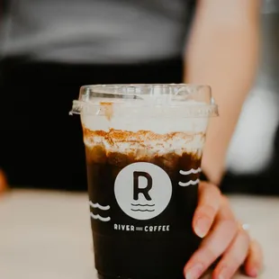 a person holding a cup of coffee