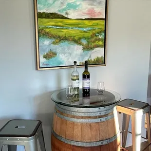 a wine barrel with two bottles of wine