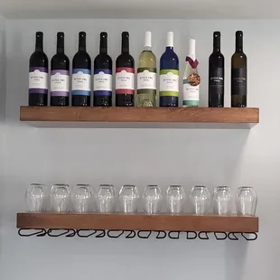 wine bottles and glasses on shelves